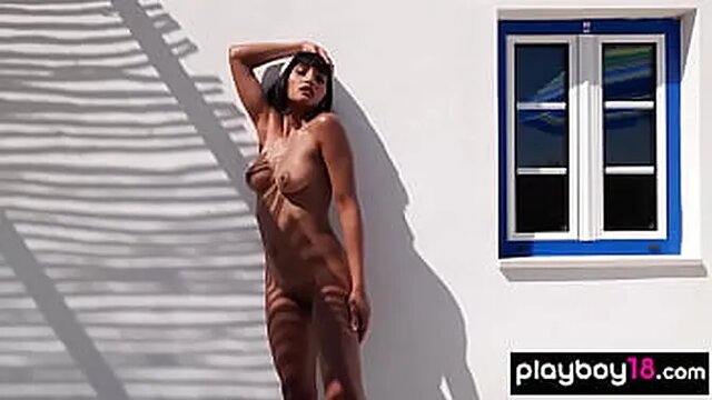 Asian babe squeezes orange on her perky tits