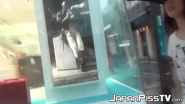 Asian babe's long pee session in public lingerie