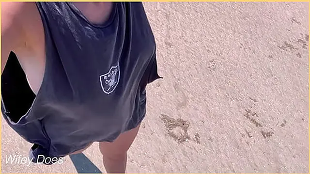 Spouse boldly shows side boob while strolling on a crowded beach