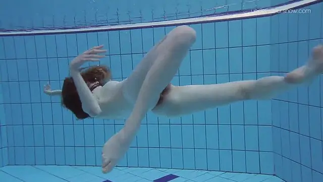 Tiny teen Anna gets wet in a poolside solo scene