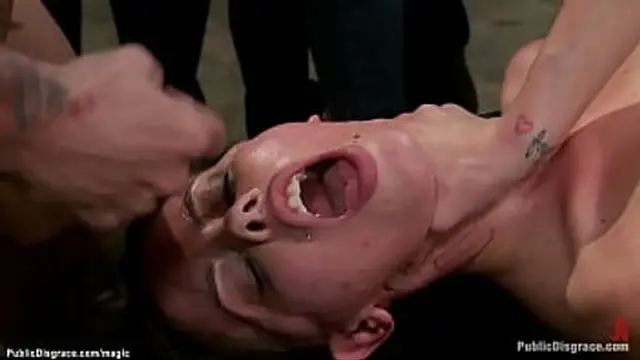 Curvy sub squirts in front of crowd